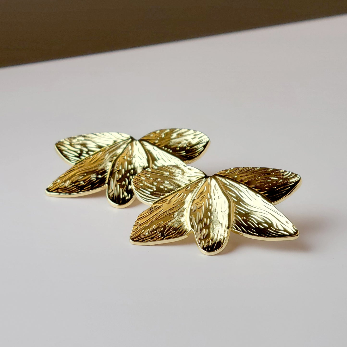 Crafted with the highest quality hypoallergenic stainless steel, these Gold Flower Leaf Stud Earrings are both sustainable and low maintenance. Say goodbye to tarnishing and hello to everyday lightweight comfort. A stylish addition to any outfit.