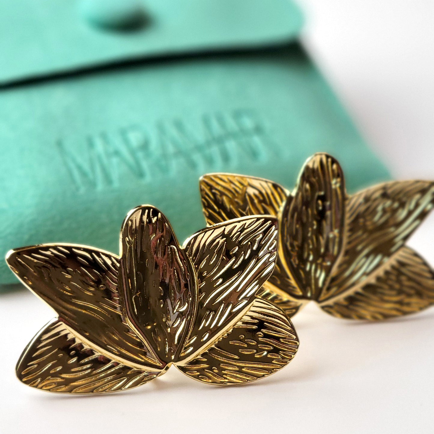Crafted with the highest quality hypoallergenic stainless steel, these Gold Flower Leaf Stud Earrings are both sustainable and low maintenance. Say goodbye to tarnishing and hello to everyday lightweight comfort. A stylish addition to any outfit.