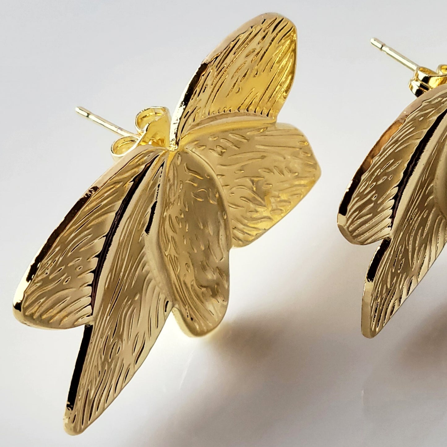 Crafted with the highest quality hypoallergenic stainless steel, these Gold Flower Leaf Stud Earrings are both sustainable and low maintenance. Say goodbye to tarnishing and hello to everyday lightweight comfort. A stylish addition to any outfit.