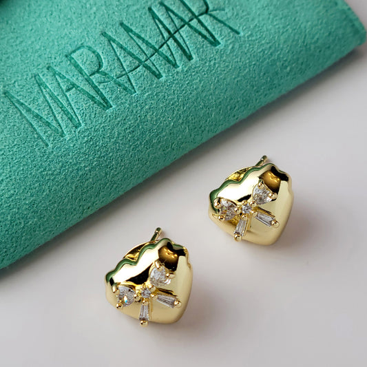 These Heart & Ribbon Stud Earrings are crafted from high-quality, hypoallergenic stainless steel that is both tarnish-proof and sustainable. Not only are these earrings low maintenance and lightweight, but they also make a great choice for those with sensitive skin. Complete your look with these stylish and eco-friendly earrings.