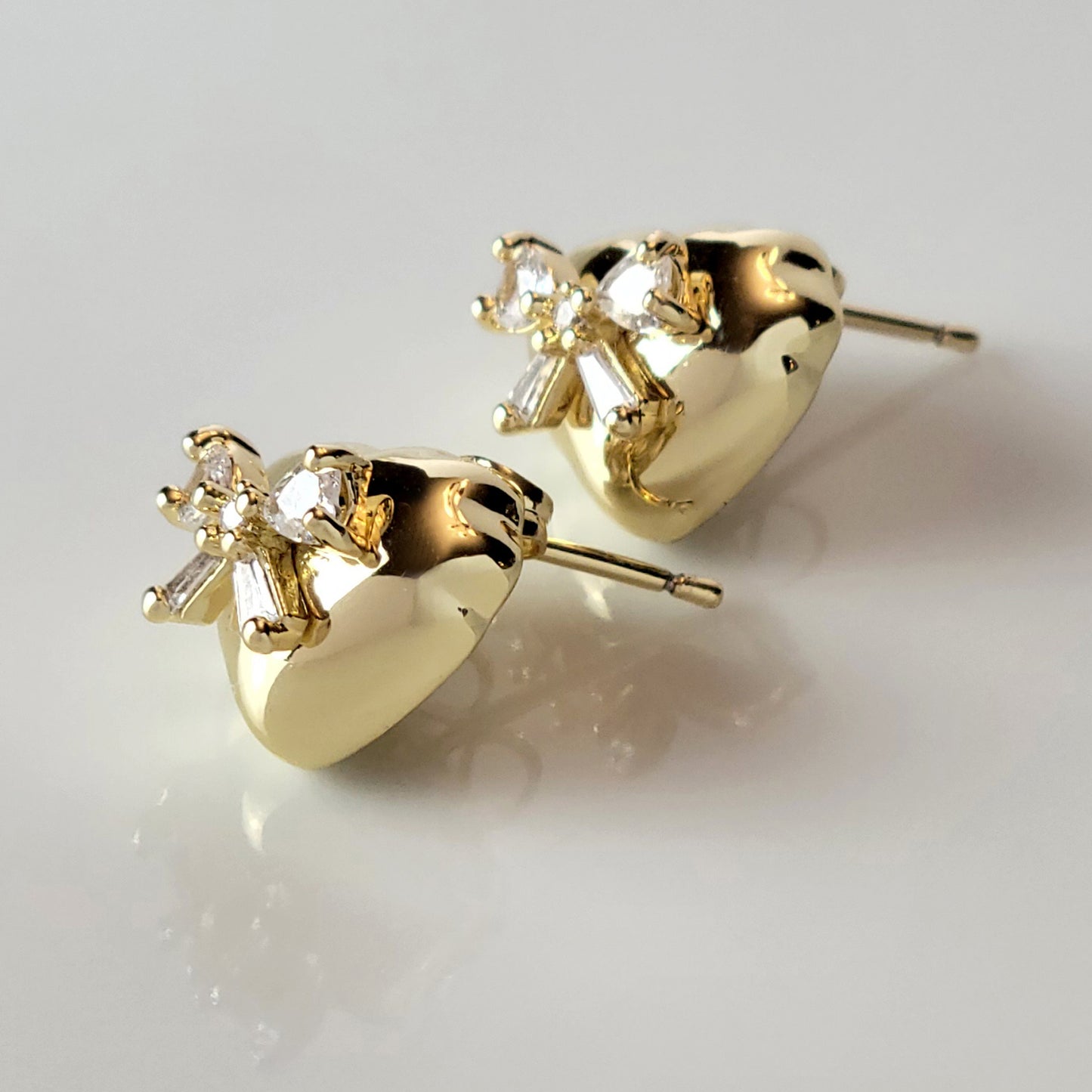 These Heart & Ribbon Stud Earrings are crafted from high-quality, hypoallergenic stainless steel that is both tarnish-proof and sustainable. Not only are these earrings low maintenance and lightweight, but they also make a great choice for those with sensitive skin. Complete your look with these stylish and eco-friendly earrings.