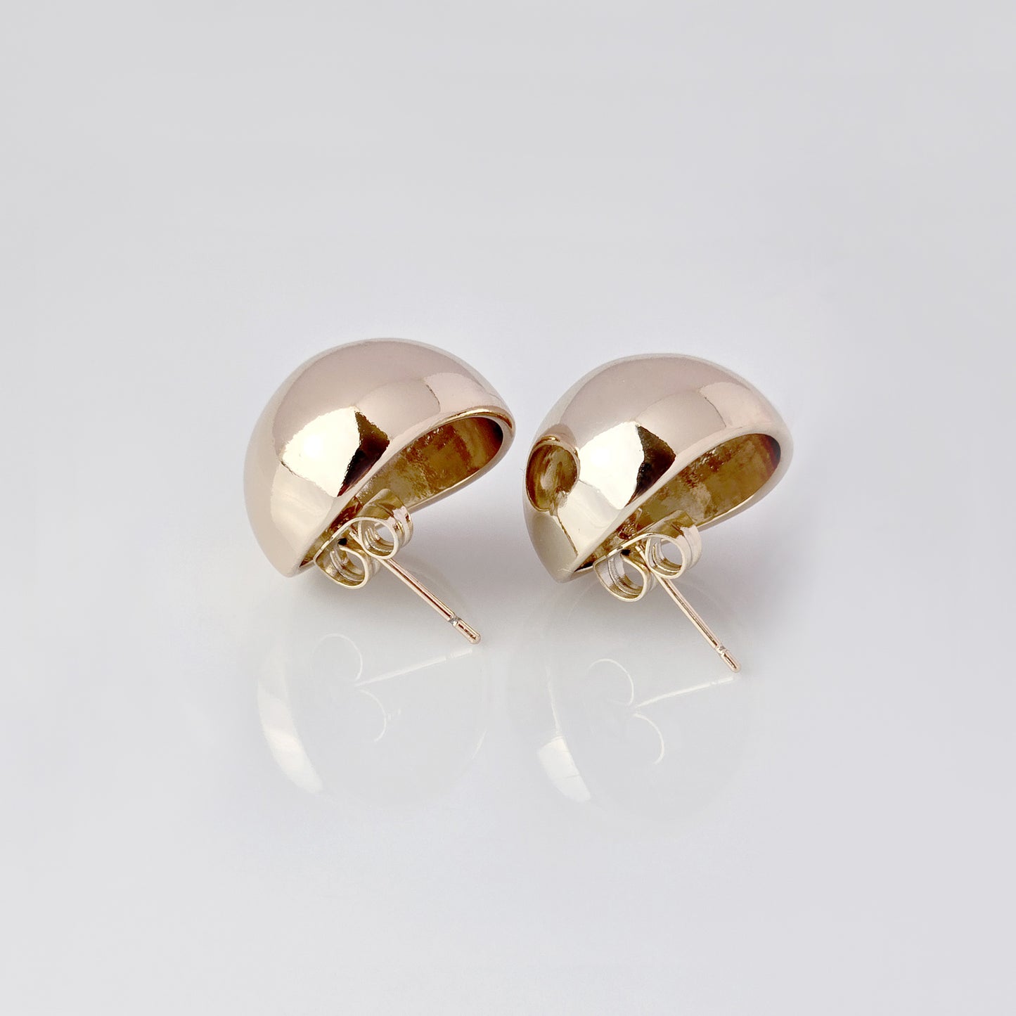 Crafted with precision and expertly designed, our Large Rose Gold Half Ball Stud Earrings are the perfect choice for those seeking high-quality and sustainable fashion. Made with hypoallergenic and tarnish-proof stainless steel, these earrings are low-maintenance and lightweight, making them a comfortable and stylish addition to any outfit.