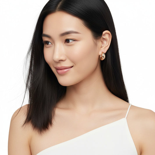 Woman wearing a white top with a plain background
