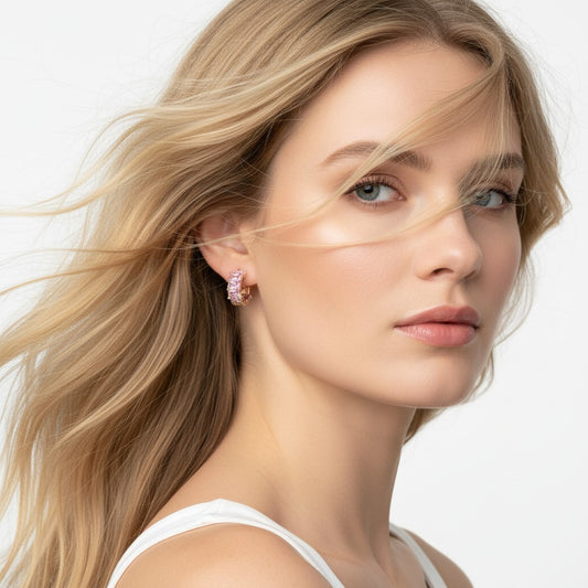 Close-up of a woman wearing pink earrings with a neutral background