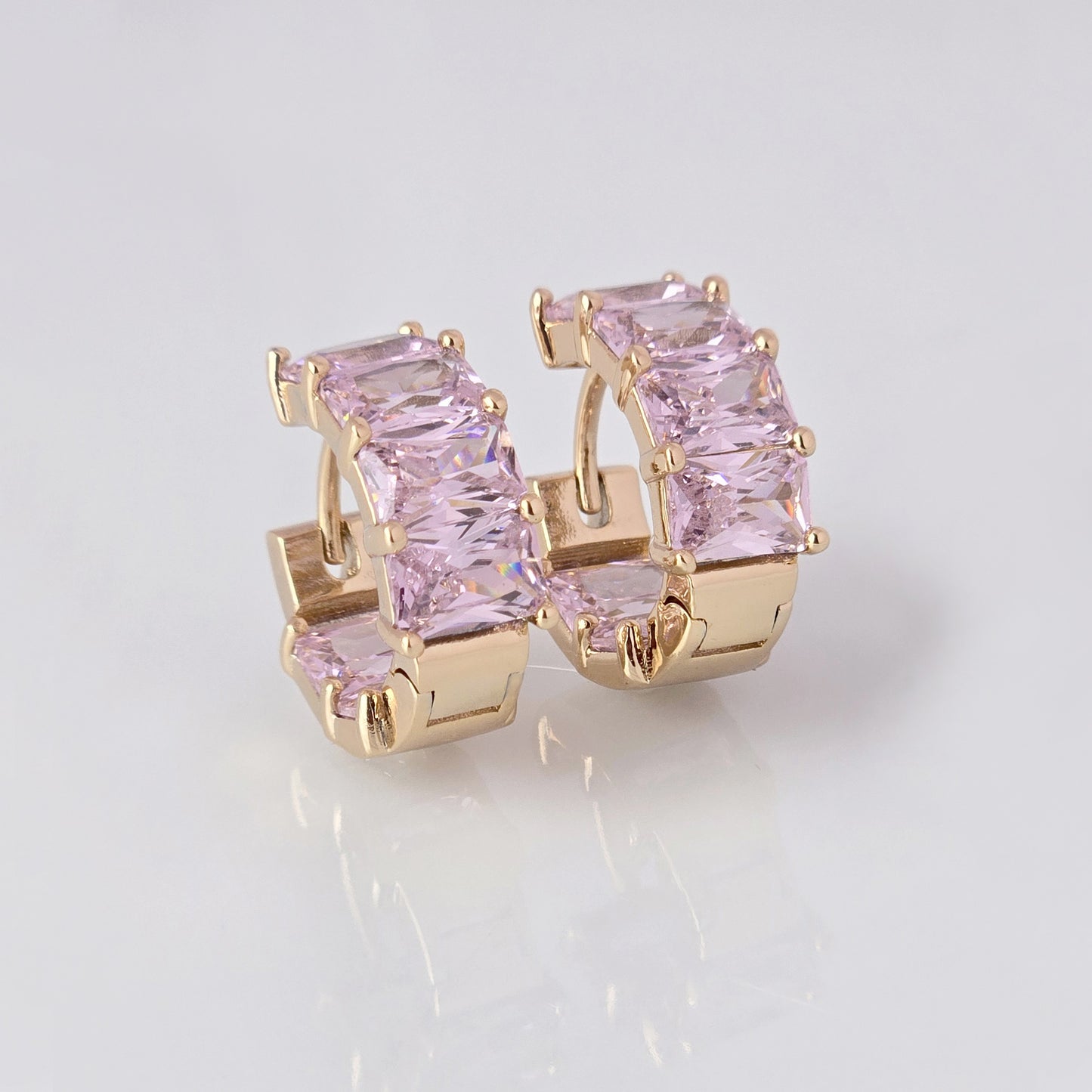 Add a touch of elegance to any outfit with our Medium Rose Gold Pink Sparkle Huggie Earrings. Made of the highest quality hypoallergenic stainless steel, these earrings are tarnish-proof and sustainable, making them a low maintenance and lightweight option for everyday wear. Elevate your style with confidence.