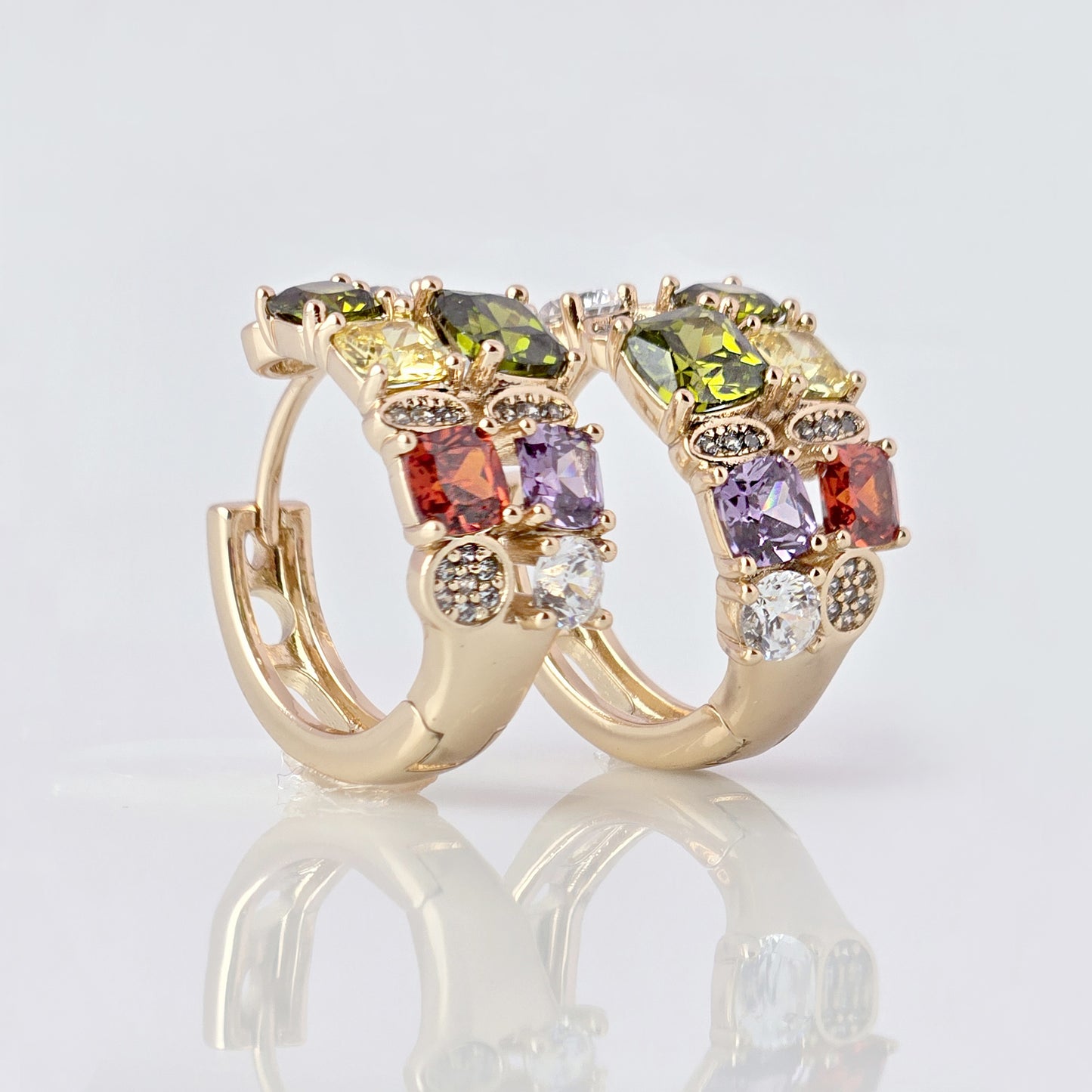 Expertly crafted from hypoallergenic, tarnish-proof stainless steel, our Medium Rose Gold Red Green Stones Huggie Earrings are both sustainable and low maintenance. The lightweight design makes them comfortable for everyday wear. Elevate your style with these quality earrings.