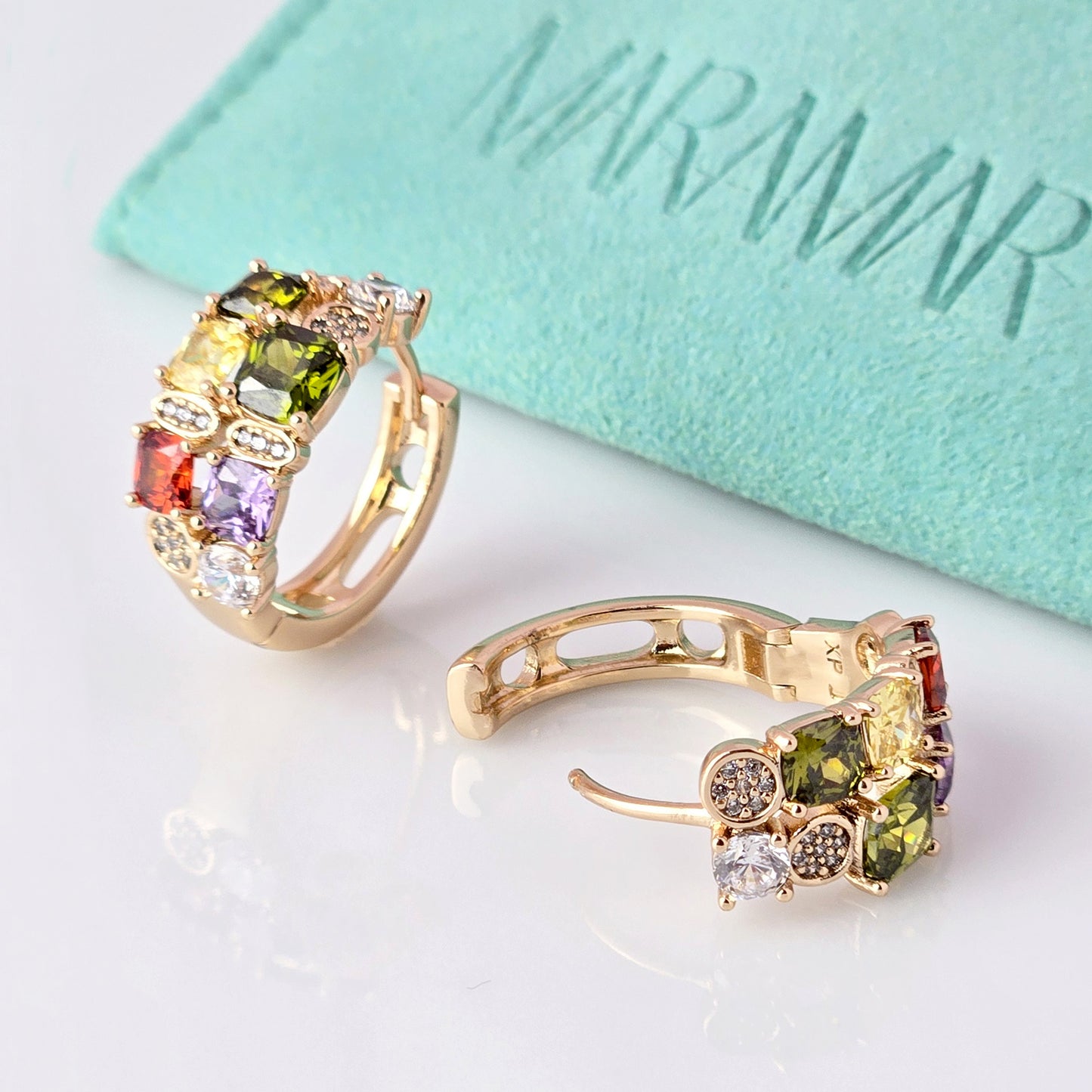 Expertly crafted from hypoallergenic, tarnish-proof stainless steel, our Medium Rose Gold Red Green Stones Huggie Earrings are both sustainable and low maintenance. The lightweight design makes them comfortable for everyday wear. Elevate your style with these quality earrings.