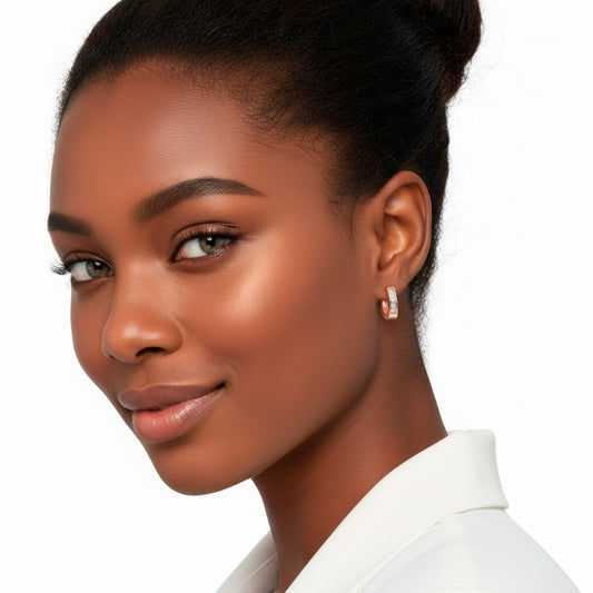 Close-up of a woman wearing a white shirt with a plain background