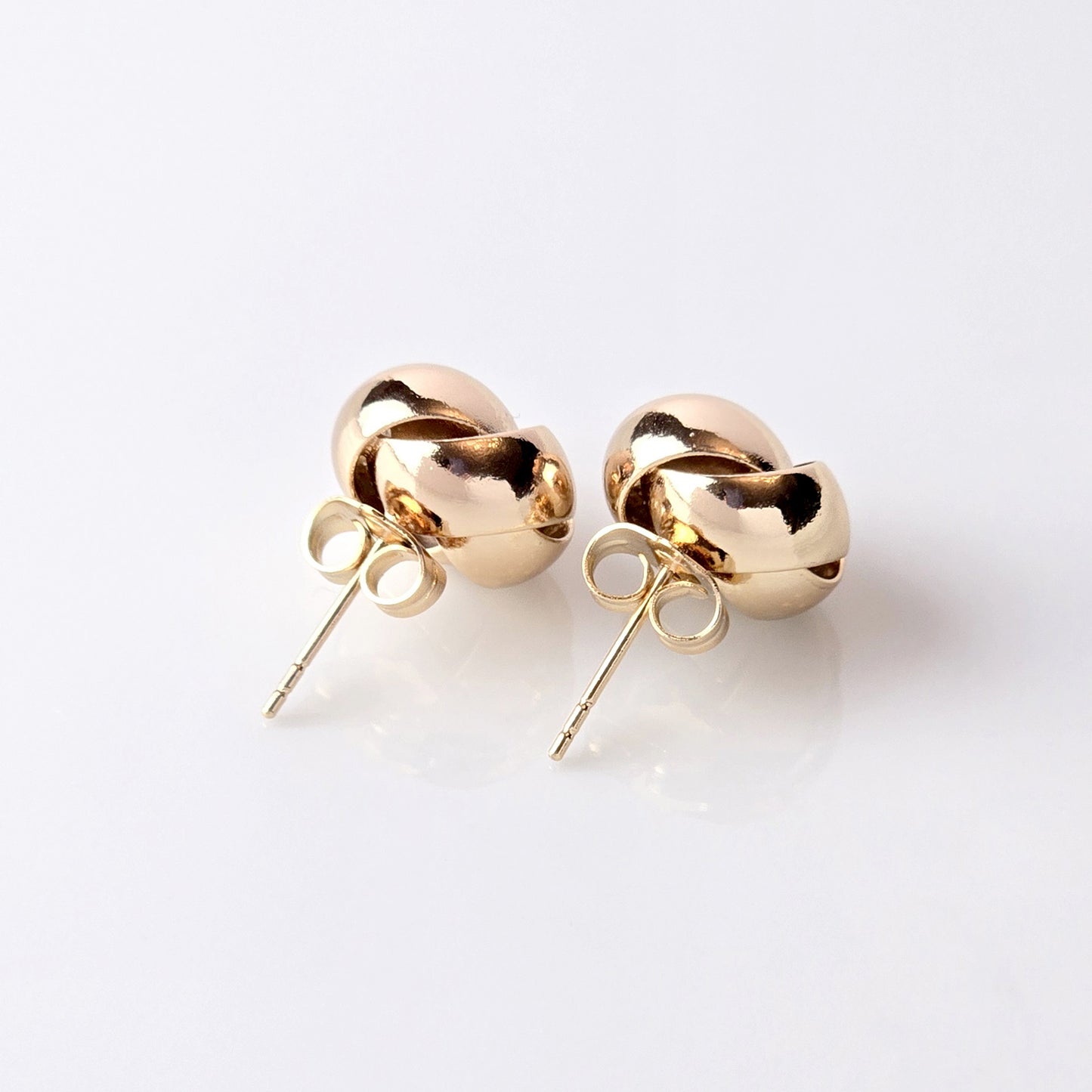 Handcrafted from sustainable and hypoallergenic stainless steel, these Rose Gold Knot Stud Earrings are perfect for everyday wear. The water-resistant, sweat-resistant, and tarnish-proof qualities make them low maintenance and long-lasting. Add a touch of elegance to any outfit with these lightweight earrings.
