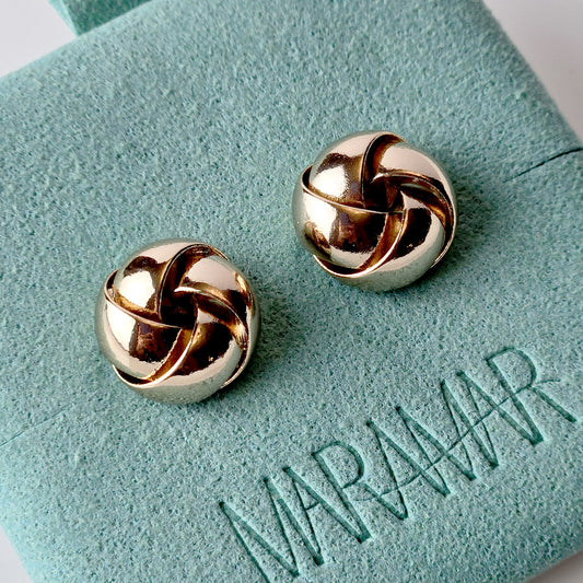Handcrafted from sustainable and hypoallergenic stainless steel, these Rose Gold Knot Stud Earrings are perfect for everyday wear. The water-resistant, sweat-resistant, and tarnish-proof qualities make them low maintenance and long-lasting. Add a touch of elegance to any outfit with these lightweight earrings.