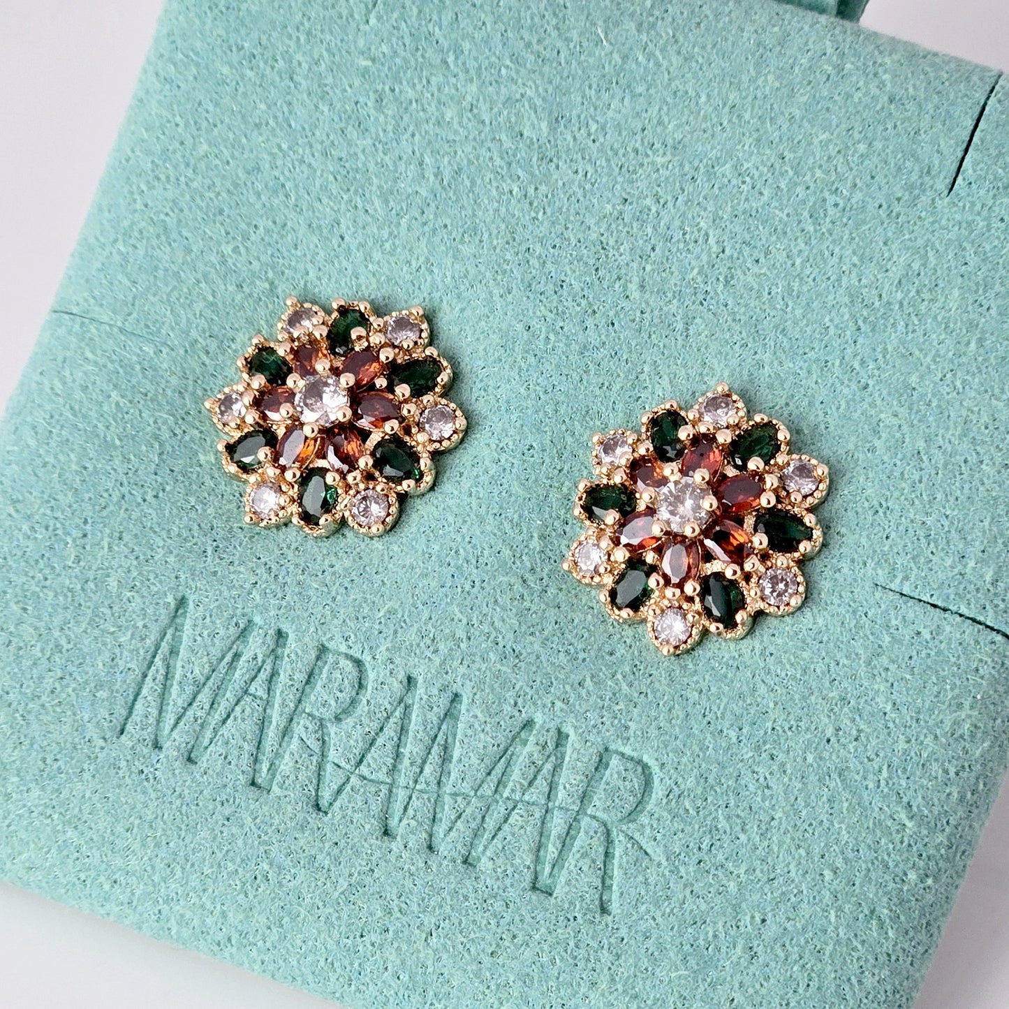 Each earring in this set of Small Rose Gold Green Red Flower Stud Earrings is made with hypoallergenic, high-quality stainless steel that is tarnish-proof and sustainable. Enjoy the benefit of low maintenance and lightweight earrings that will add a touch of color and elegance to any outfit.