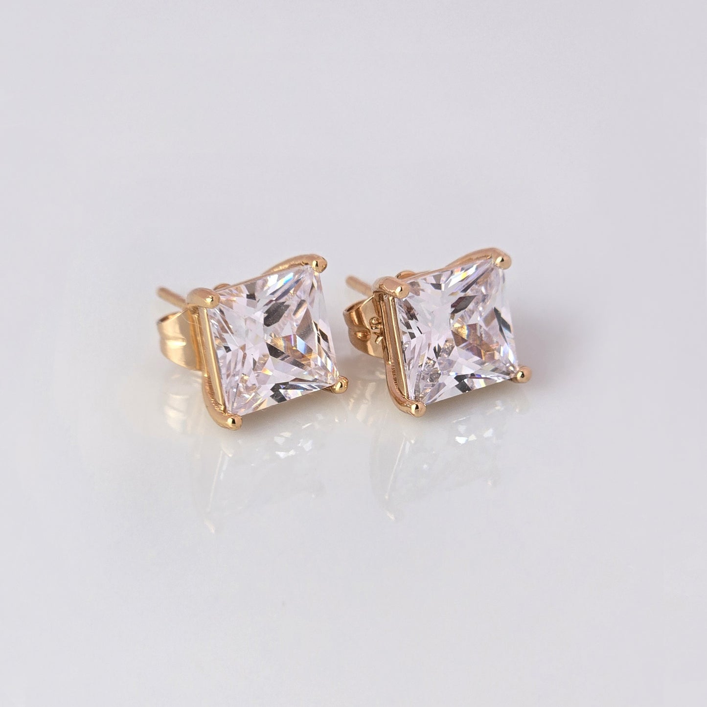 Upgrade your jewelry collection with our Small Rose Gold Princess Cut Stud Earrings. Crafted from hypoallergenic, tarnish-proof stainless steel, these earrings are both sustainable and low maintenance. Enjoy the lightweight design and timeless beauty of this high-quality piece.