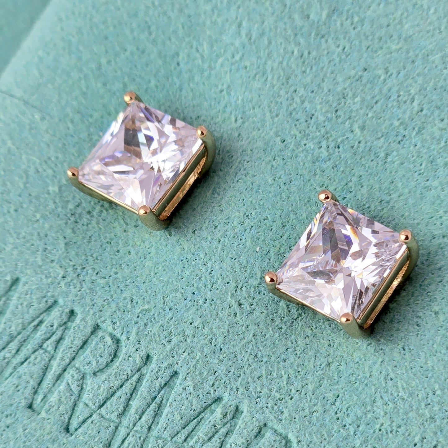 Upgrade your jewelry collection with our Small Rose Gold Princess Cut Stud Earrings. Crafted from hypoallergenic, tarnish-proof stainless steel, these earrings are both sustainable and low maintenance. Enjoy the lightweight design and timeless beauty of this high-quality piece.