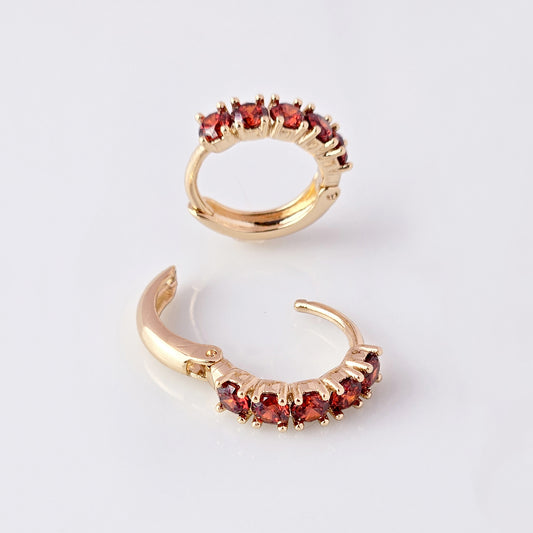 Elevate your style with our Small Rose Gold Red Garnet Huggie Earrings. Made from high-quality hypoallergenic stainless steel, these earrings are sustainable, tarnish-proof, and low maintenance while still remaining lightweight. The small size and elegant cut of the red garnet make for a perfect everyday accessory that adds a touch of sophistication to any outfit.