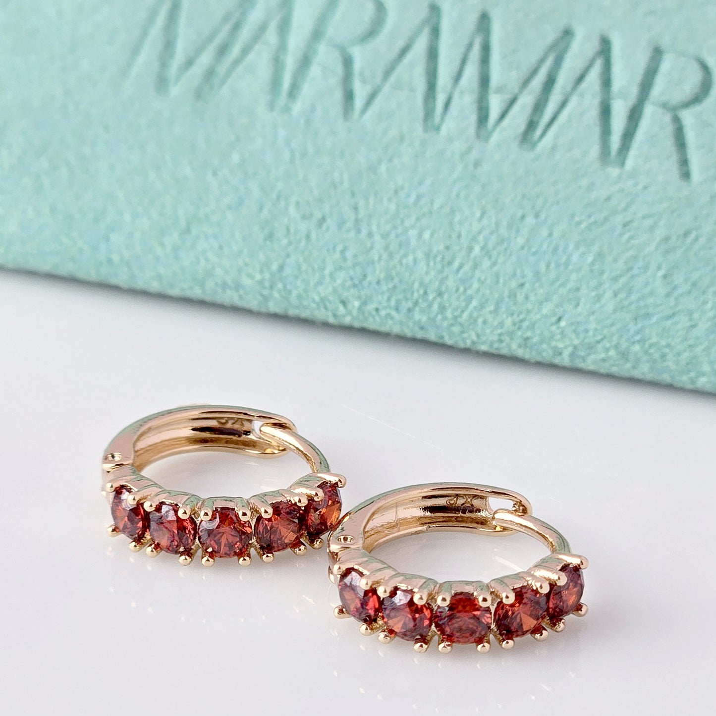 Elevate your style with our Small Rose Gold Red Garnet Huggie Earrings. Made from high-quality hypoallergenic stainless steel, these earrings are sustainable, tarnish-proof, and low maintenance while still remaining lightweight. The small size and elegant cut of the red garnet make for a perfect everyday accessory that adds a touch of sophistication to any outfit.