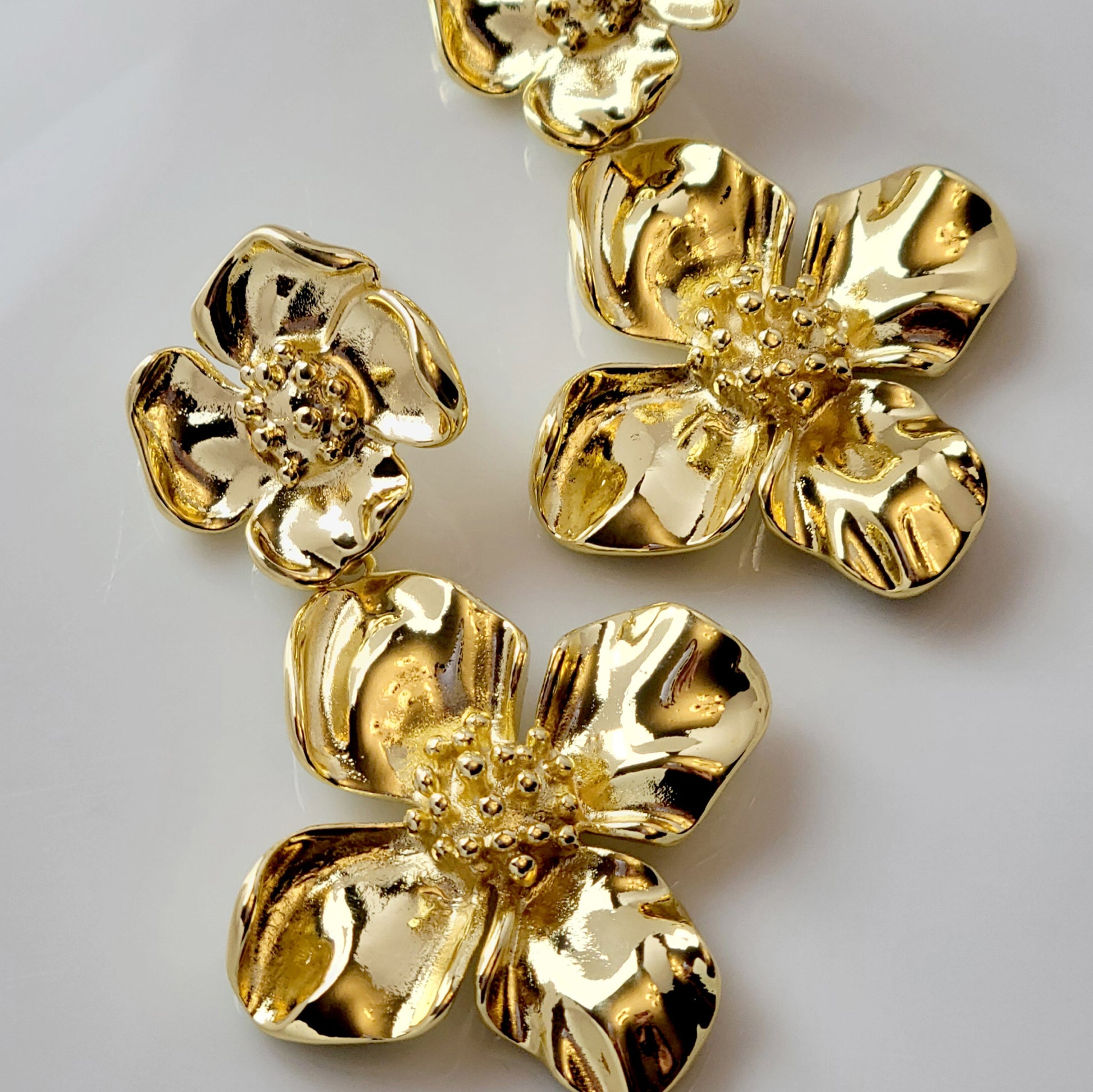Expertly crafted with hypoallergenic stainless steel, our Double Flower Dangle Earrings are both sustainable and low maintenance. With superior quality and lightweight design, these earrings are perfect for everyday wear. Say goodbye to tarnishing and hello to timeless style.