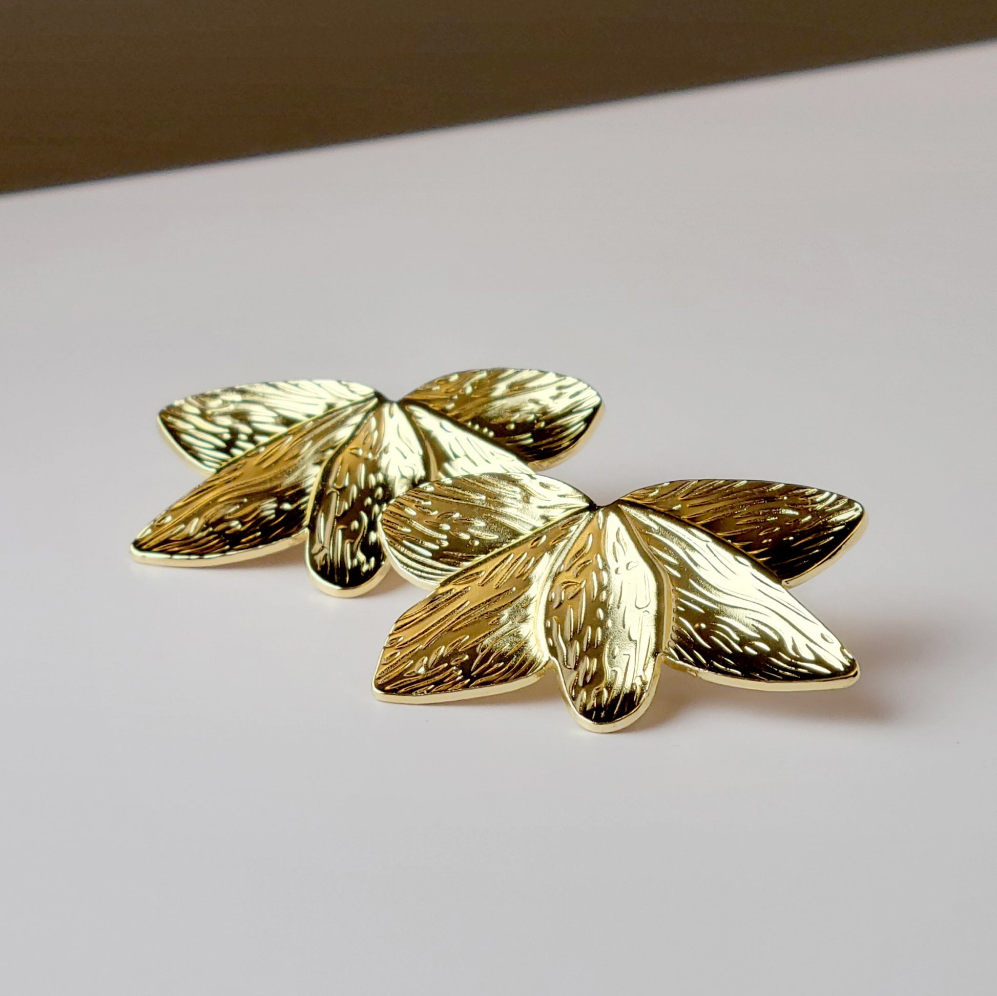 Crafted with the highest quality hypoallergenic stainless steel, these Gold Flower Leaf Stud Earrings are both sustainable and low maintenance. Say goodbye to tarnishing and hello to everyday lightweight comfort. A stylish addition to any outfit.