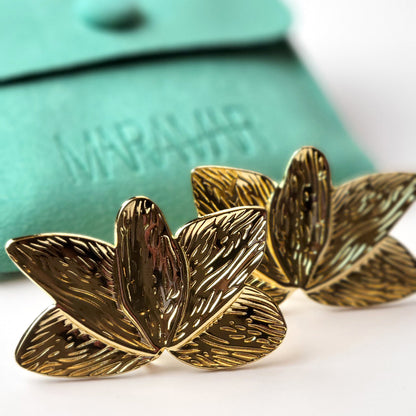 Crafted with the highest quality hypoallergenic stainless steel, these Gold Flower Leaf Stud Earrings are both sustainable and low maintenance. Say goodbye to tarnishing and hello to everyday lightweight comfort. A stylish addition to any outfit.