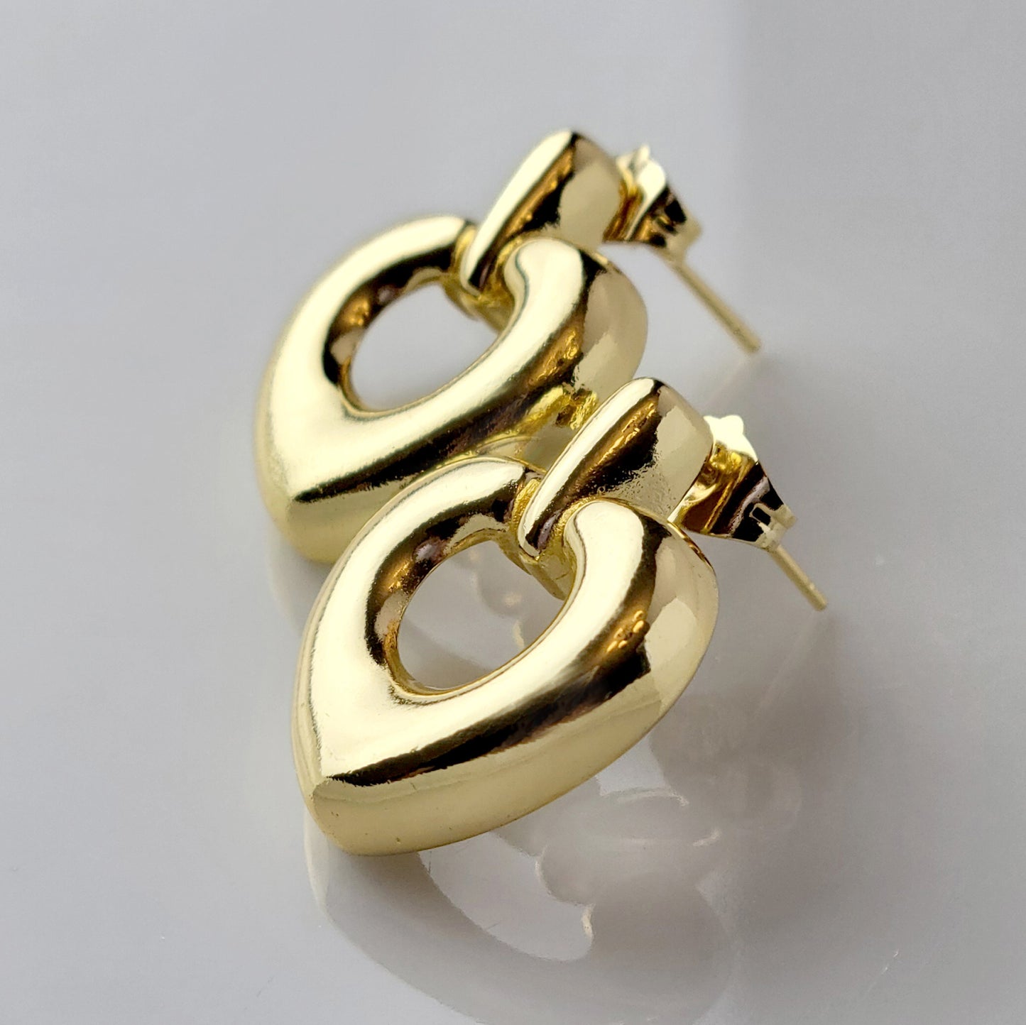 Introducing our Gold Heart Dangle Earrings, crafted from hypoallergenic, tarnish-proof stainless steel. These earrings are not only sustainable, but also low maintenance and lightweight for comfortable wear. Upgrade your style with the highest quality and durability.