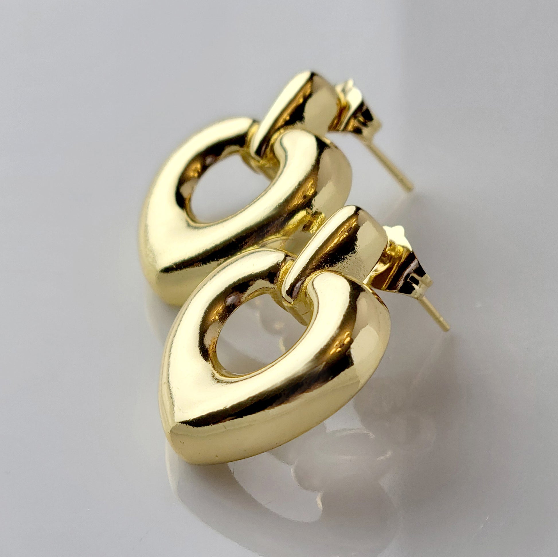 Introducing our Gold Heart Dangle Earrings, crafted from hypoallergenic, tarnish-proof stainless steel. These earrings are not only sustainable, but also low maintenance and lightweight for comfortable wear. Upgrade your style with the highest quality and durability.
