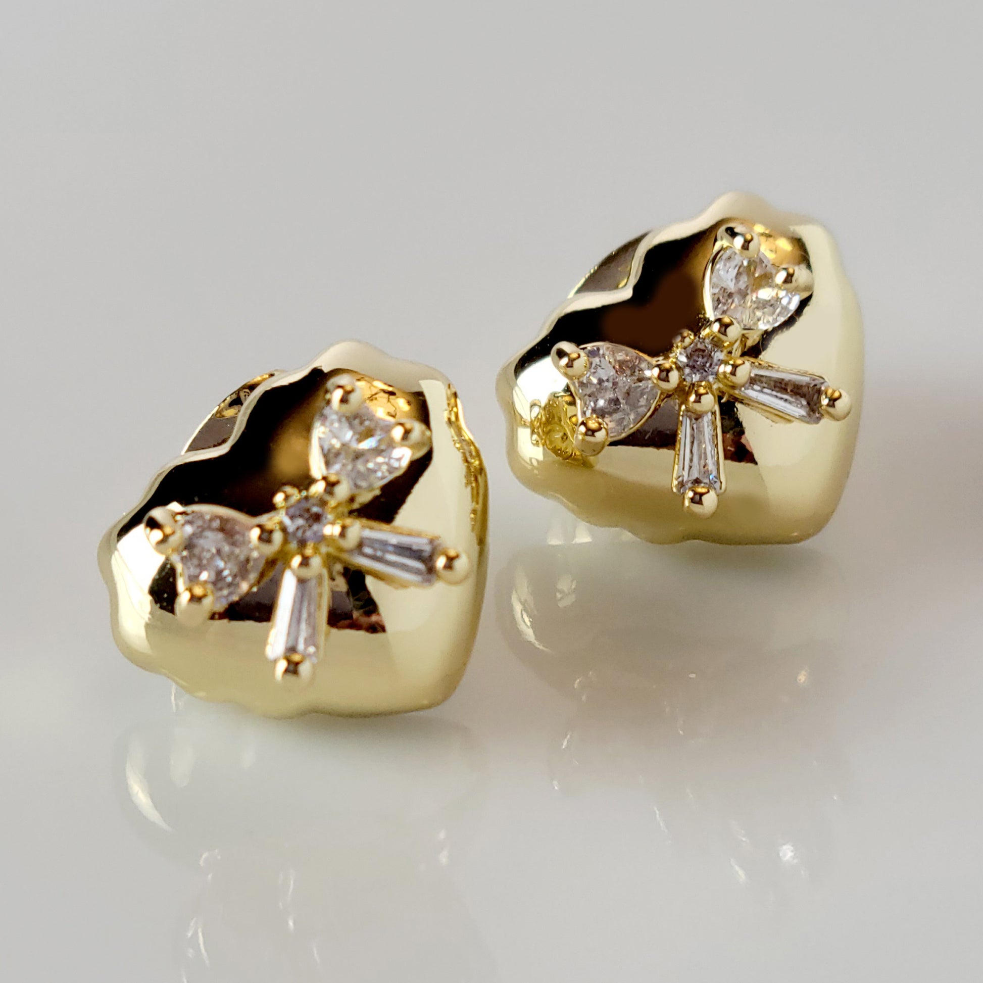 These Heart &amp; Ribbon Stud Earrings are crafted from high-quality, hypoallergenic stainless steel that is both tarnish-proof and sustainable. Not only are these earrings low maintenance and lightweight, but they also make a great choice for those with sensitive skin. Complete your look with these stylish and eco-friendly earrings.
