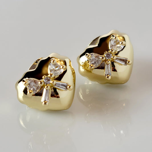 These Heart &amp; Ribbon Stud Earrings are crafted from high-quality, hypoallergenic stainless steel that is both tarnish-proof and sustainable. Not only are these earrings low maintenance and lightweight, but they also make a great choice for those with sensitive skin. Complete your look with these stylish and eco-friendly earrings.