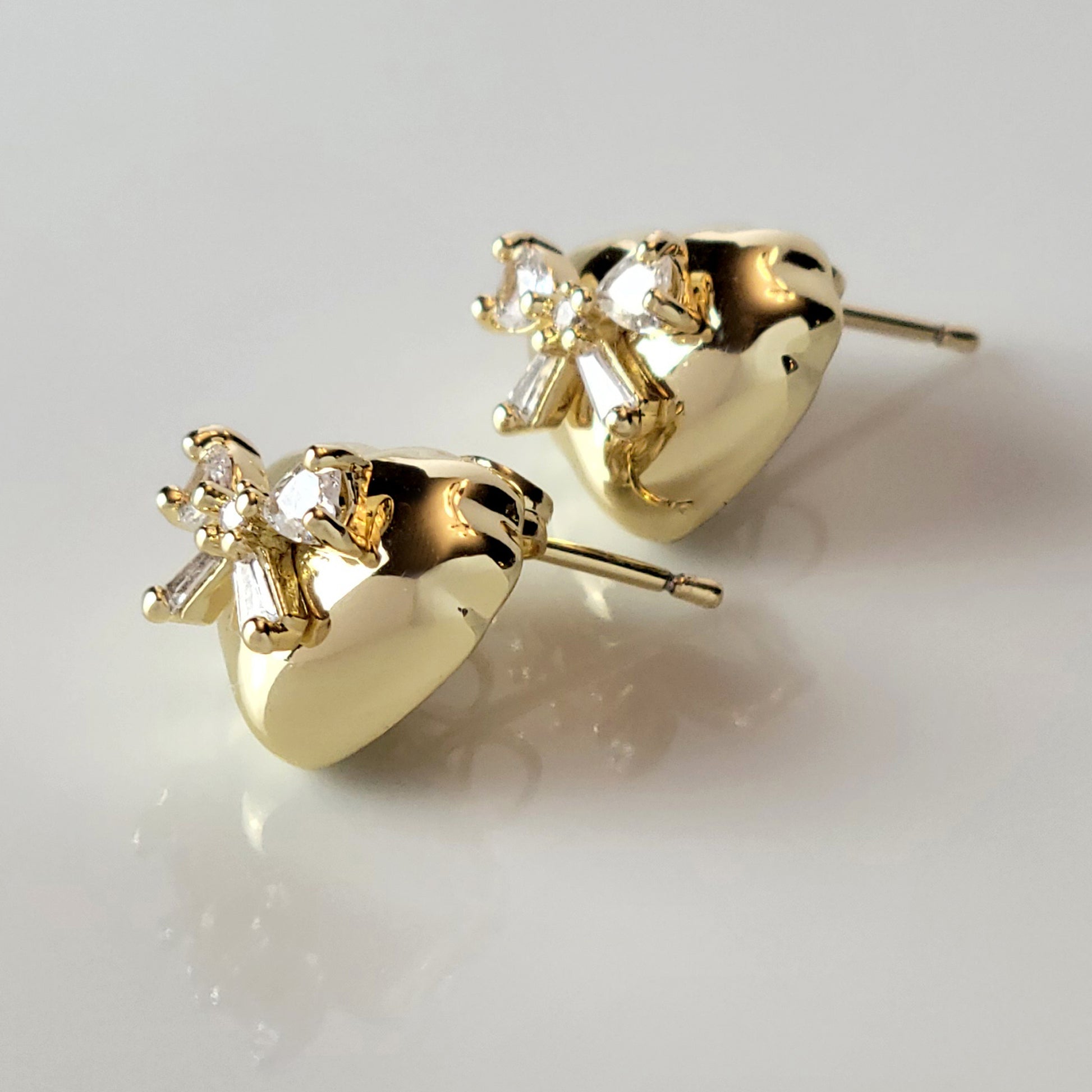 These Heart &amp; Ribbon Stud Earrings are crafted from high-quality, hypoallergenic stainless steel that is both tarnish-proof and sustainable. Not only are these earrings low maintenance and lightweight, but they also make a great choice for those with sensitive skin. Complete your look with these stylish and eco-friendly earrings.
