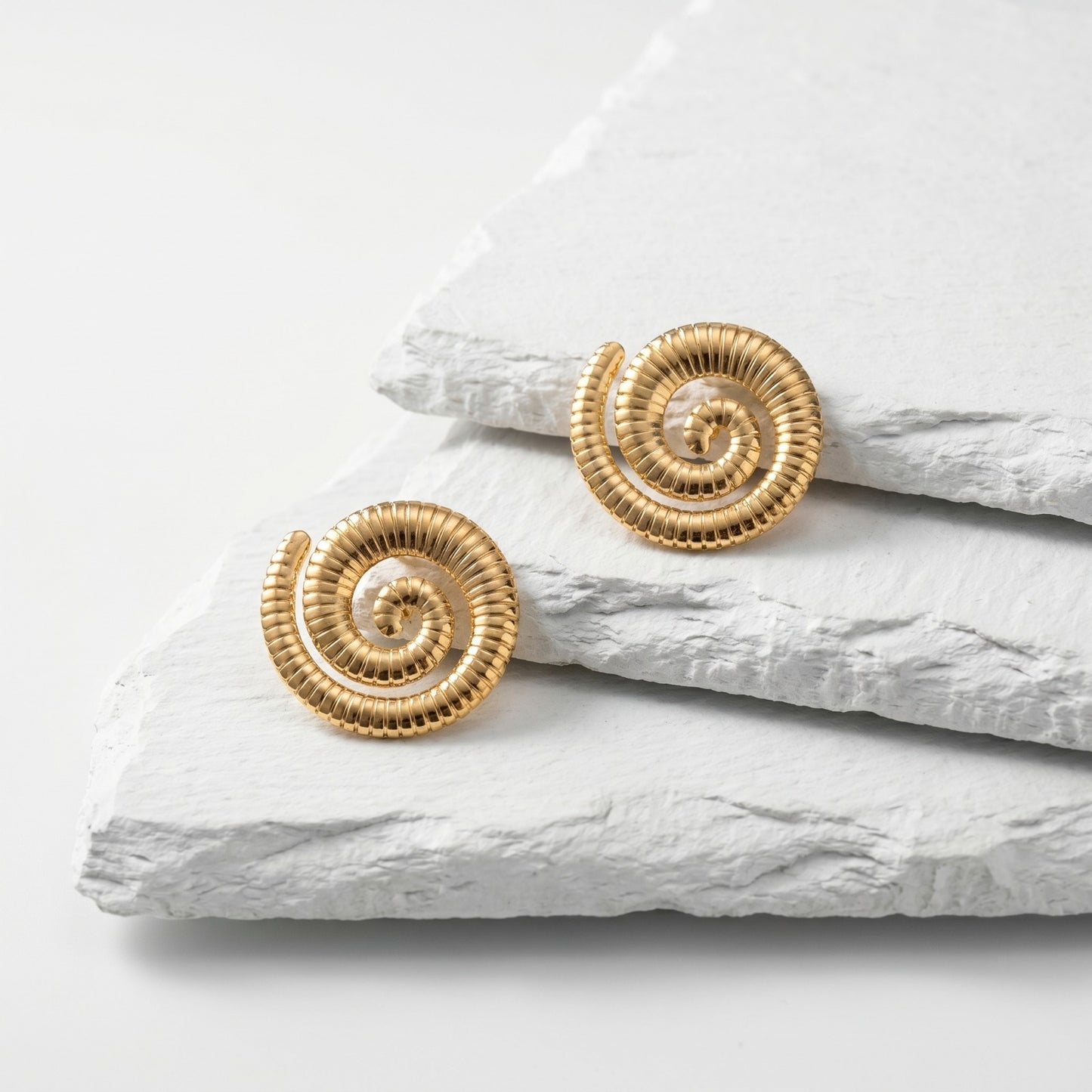 Large Golden Spiral Stud Earrings featuring an elegant spiral design in waterproof stainless steel.