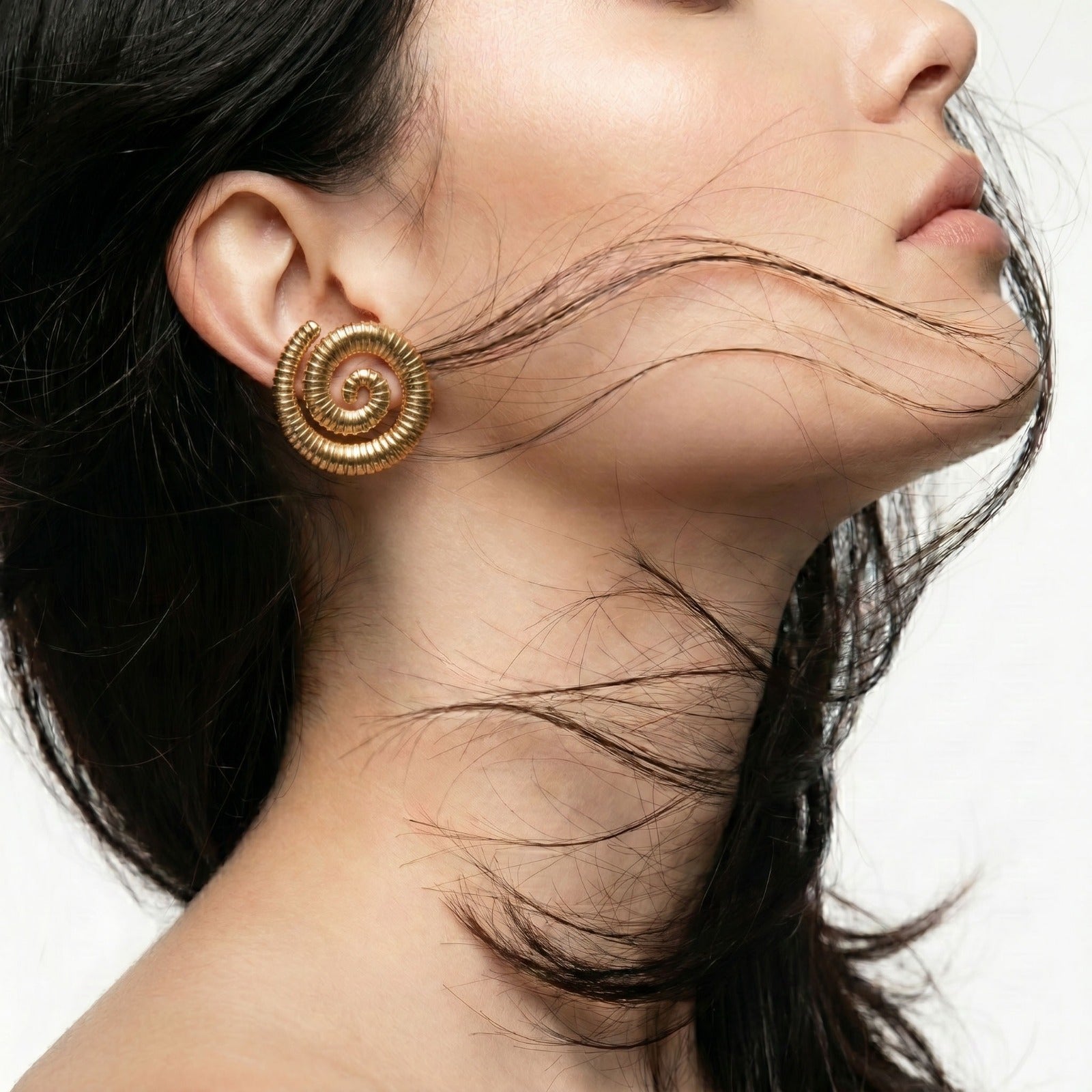 Large Golden Spiral Stud Earrings featuring an elegant spiral design in waterproof stainless steel.