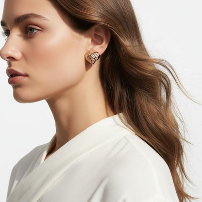 Close-up of a woman wearing a gold earring with a white background