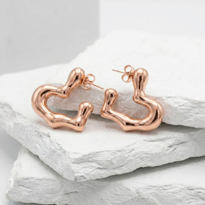 Rose gold hoop earrings on a light gray background premium stainless steel hypoallergenic, waterproof, tarnish-proof, and lightweight