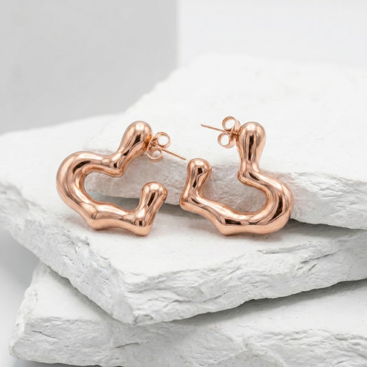 Rose gold hoop earrings on a light gray background premium stainless steel hypoallergenic, waterproof, tarnish-proof, and lightweight