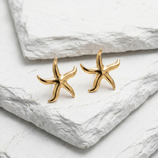 Inspired by treasures found along the shoreline, these elegant starfish earrings were handpicked for the MarAmar Coastal Elegance Collection. Featuring a polished gold finish and stainless steel construction, they offer waterproof durability and lasting beauty. The perfect accessory for effortless coastal sophistication.