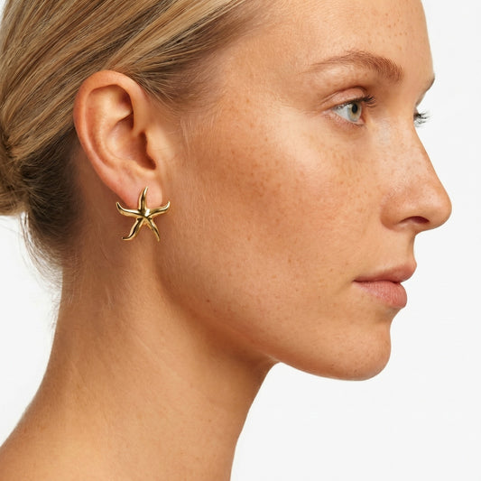 Inspired by treasures found along the shoreline, these elegant starfish earrings were handpicked for the MarAmar Coastal Elegance Collection. Featuring a polished gold finish and stainless steel construction, they offer waterproof durability and lasting beauty. The perfect accessory for effortless coastal sophistication.