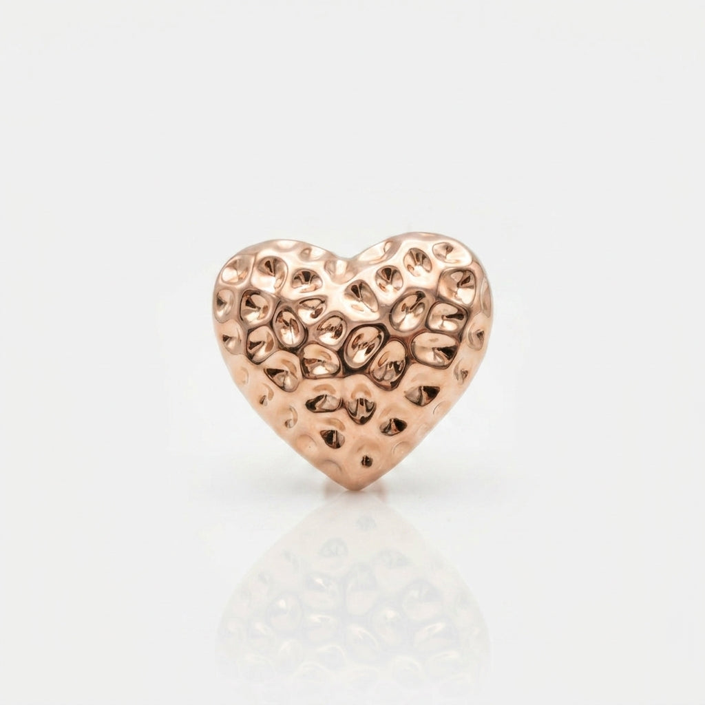 Rose gold heart-shaped jewelry charm on a light gray background Medium Rose Gold Amora Heart Stud Earrings premium stainless steel hypoallergenic, waterproof, tarnish-proof, and lightweight