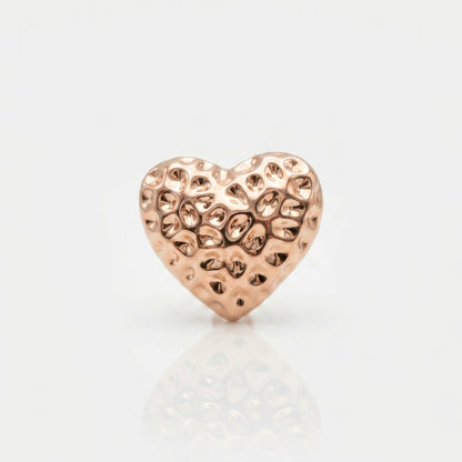 Rose gold heart-shaped jewelry charm on a light gray background Medium Rose Gold Amora Heart Stud Earrings premium stainless steel hypoallergenic, waterproof, tarnish-proof, and lightweight