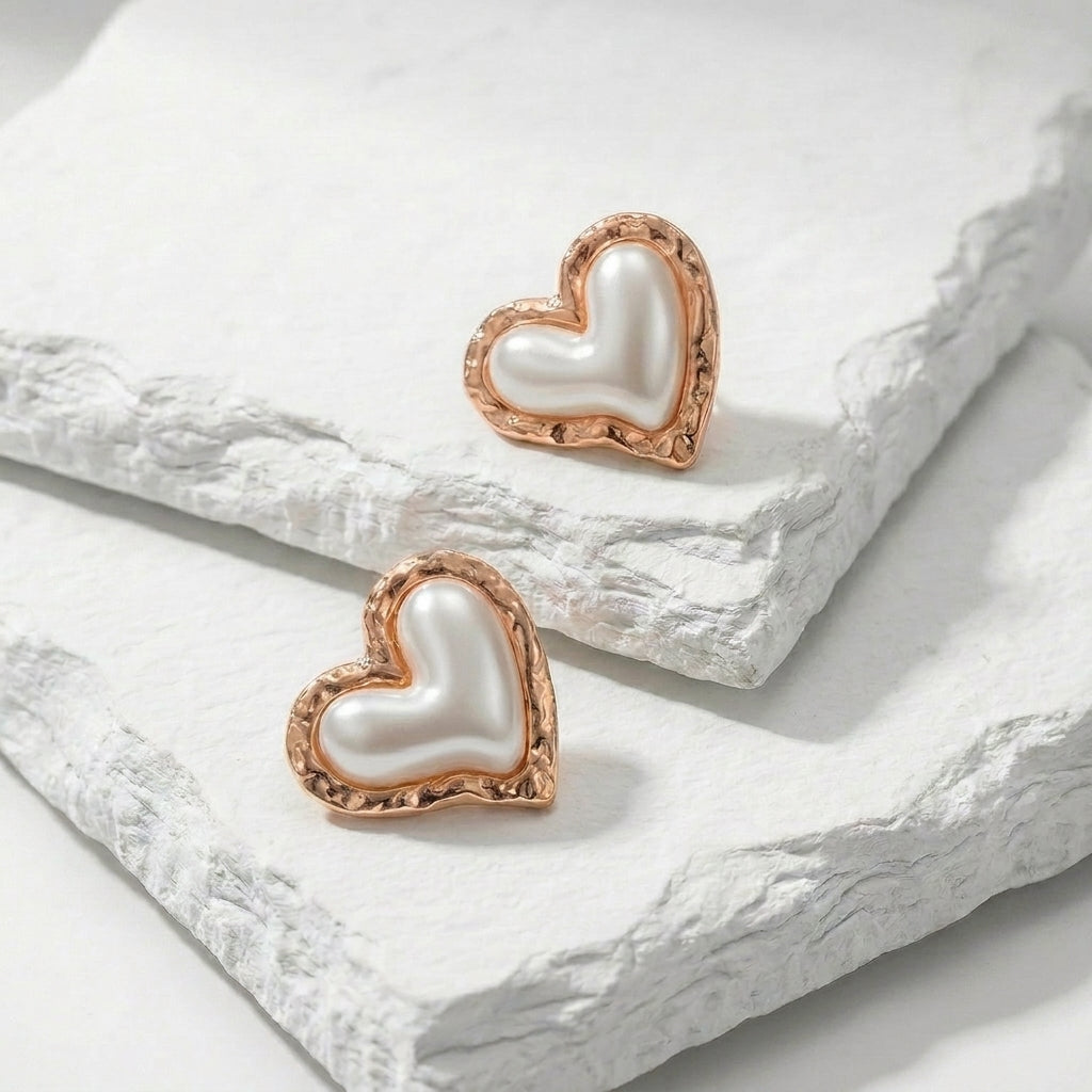 Heart-shaped earrings with rose gold frames on a white stone surface Medium Rose Gold Coral Heart Stud Earrings premium stainless steel hypoallergenic, waterproof, tarnish-proof, and lightweight