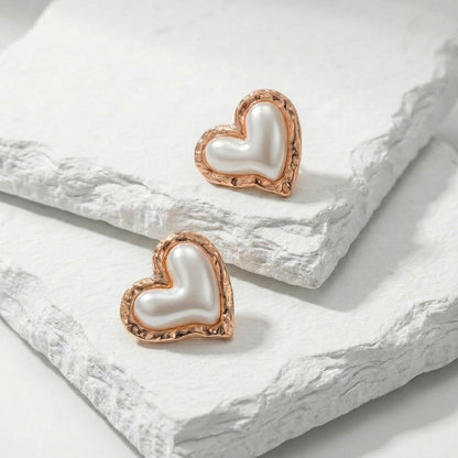Heart-shaped earrings with rose gold frames on a white stone surface Medium Rose Gold Coral Heart Stud Earrings premium stainless steel hypoallergenic, waterproof, tarnish-proof, and lightweight