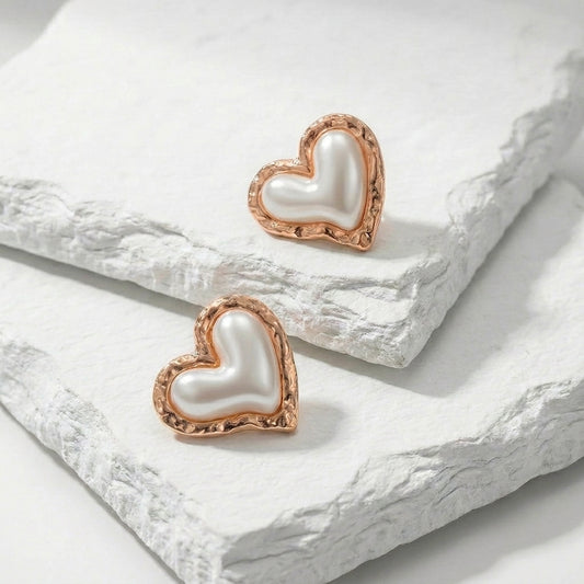Heart-shaped earrings with rose gold frames on a white stone surface Medium Rose Gold Coral Heart Stud Earrings premium stainless steel hypoallergenic, waterproof, tarnish-proof, and lightweight