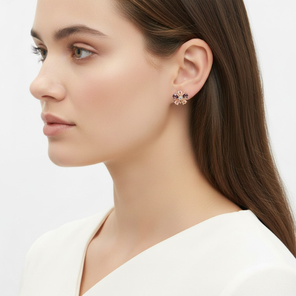 Close-up of a woman wearing a floral earring on a plain background