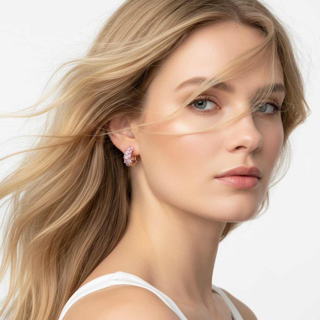 Close-up of a woman wearing pink earrings with a neutral background