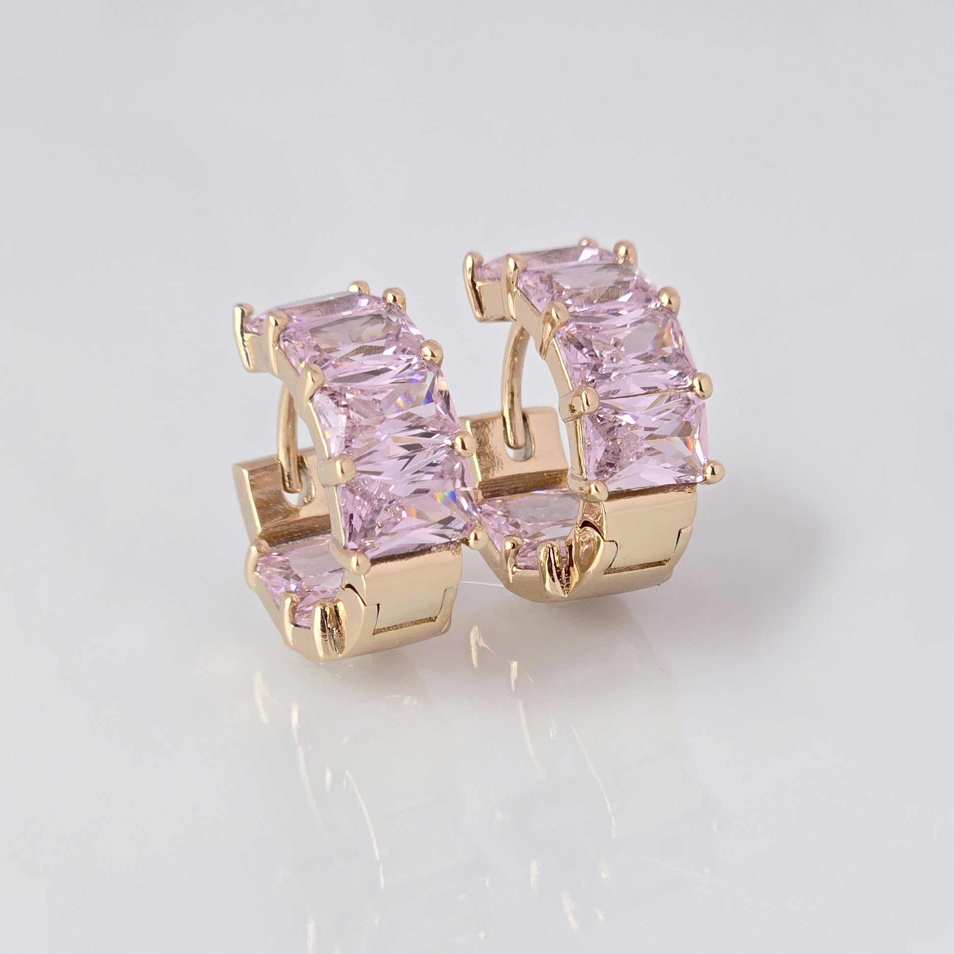 Add a touch of elegance to any outfit with our Medium Rose Gold Pink Sparkle Huggie Earrings. Made of the highest quality hypoallergenic stainless steel, these earrings are tarnish-proof and sustainable, making them a low maintenance and lightweight option for everyday wear. Elevate your style with confidence.