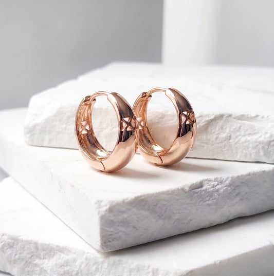 Made with the highest quality hypoallergenic, tarnish-proof stainless steel, our Medium Rose Gold Pure Huggie Earrings  are both sustainable and low maintenance. You can wear these lightweight earrings every day without worrying about any allergic reactions or tarnishing. Upgrade your jewelry collection with these timeless and durable studs.