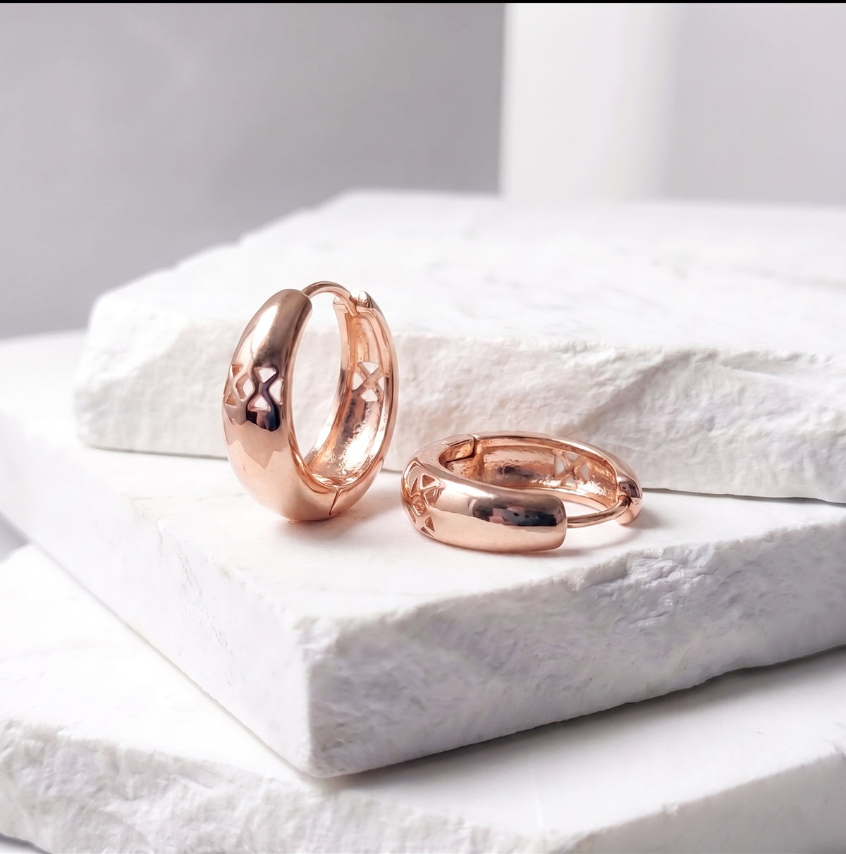 Made with the highest quality hypoallergenic, tarnish-proof stainless steel, our Medium Rose Gold Pure Huggie Earrings  are both sustainable and low maintenance. You can wear these lightweight earrings every day without worrying about any allergic reactions or tarnishing. Upgrade your jewelry collection with these timeless and durable studs.