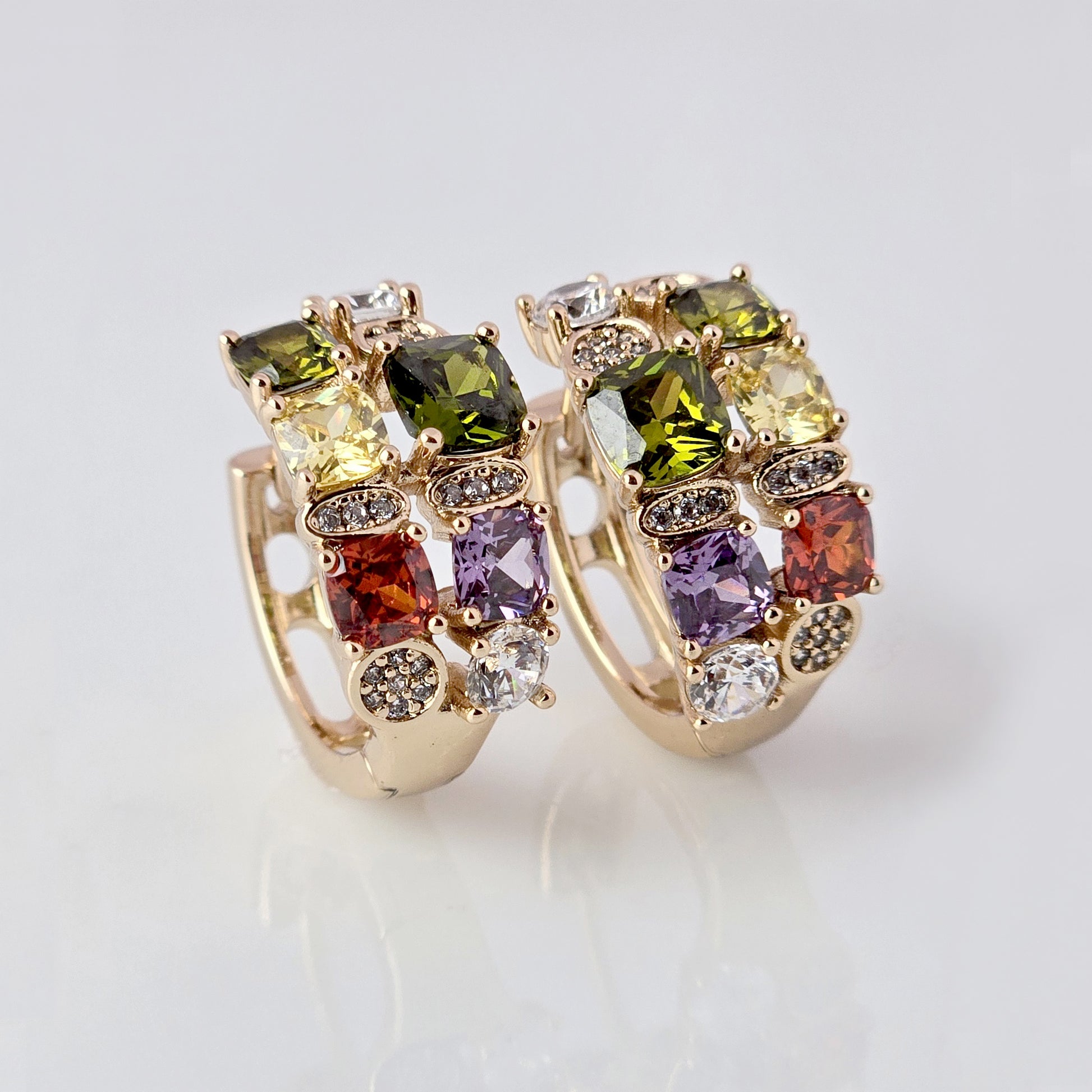 Expertly crafted from hypoallergenic, tarnish-proof stainless steel, our Medium Rose Gold Red Green Stones Huggie Earrings are both sustainable and low maintenance. The lightweight design makes them comfortable for everyday wear. Elevate your style with these quality earrings.