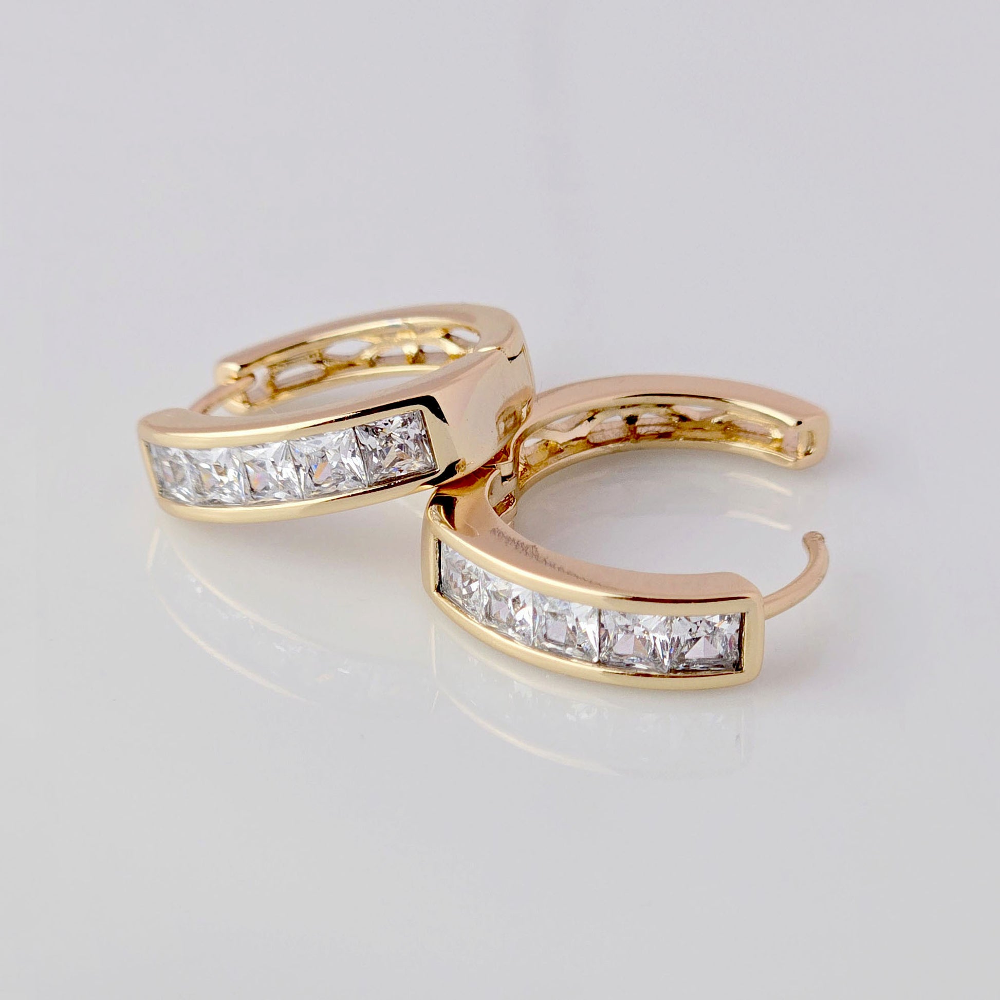 These Medium Rose Gold Sparkle Huggie Earrings are crafted with the highest quality hypoallergenic stainless steel, making them tarnish-proof and sustainable. Their low maintenance and lightweight design provides both comfort and durability. Perfect for adding a touch of elegance to any outfit.