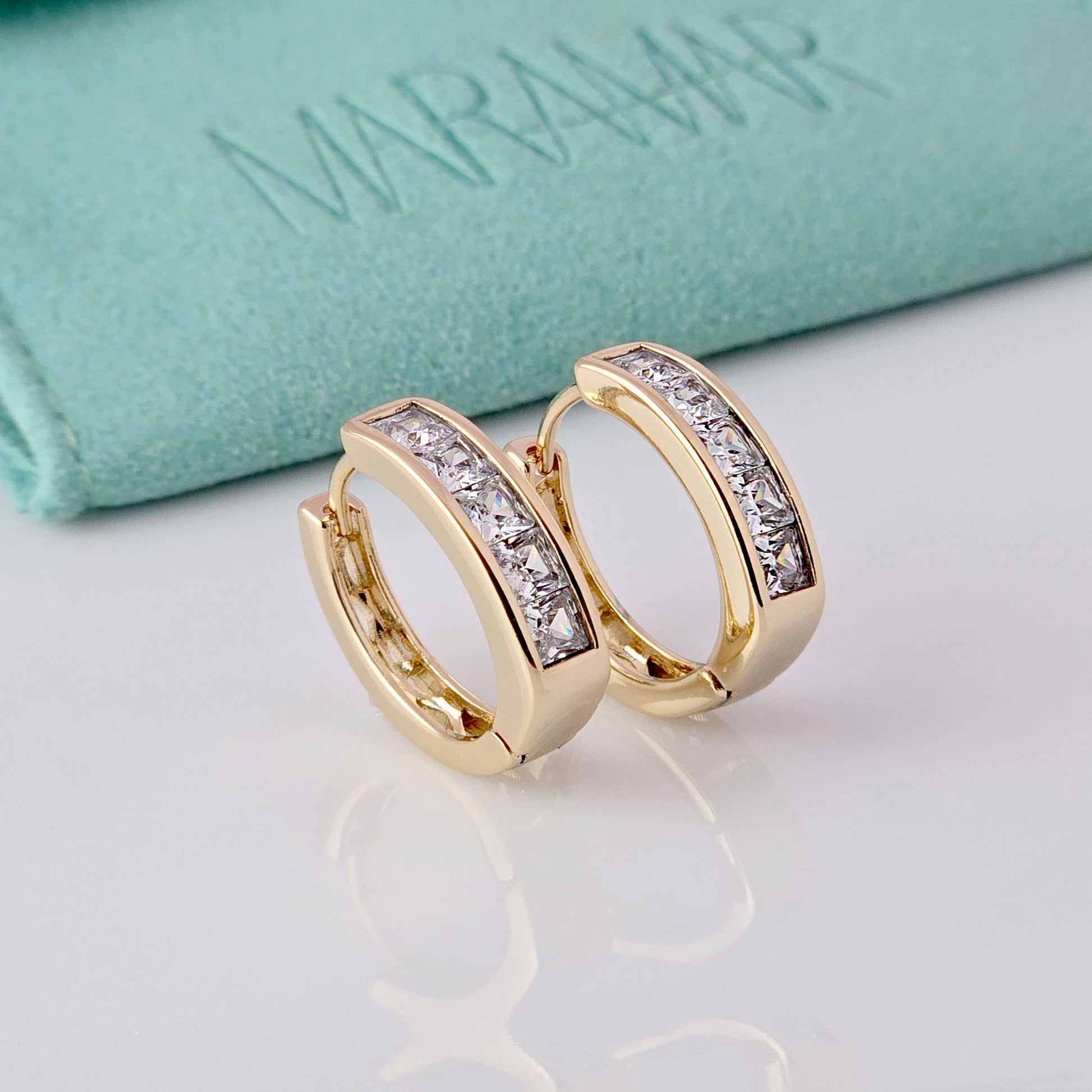 These Medium Rose Gold Sparkle Huggie Earrings are crafted with the highest quality hypoallergenic stainless steel, making them tarnish-proof and sustainable. Their low maintenance and lightweight design provides both comfort and durability. Perfect for adding a touch of elegance to any outfit.