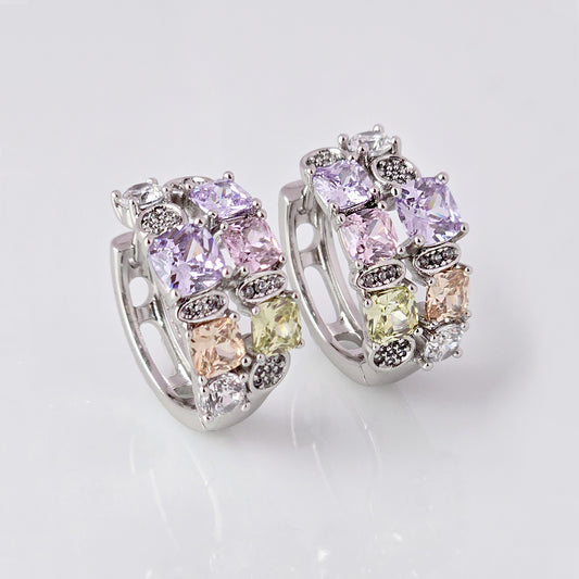 These elegant huggie earrings feature medium-sized silver pink and purple stones. Made from hypoallergenic, tarnish-proof, and sustainable stainless steel, they are low maintenance and lightweight for comfortable all-day wear.