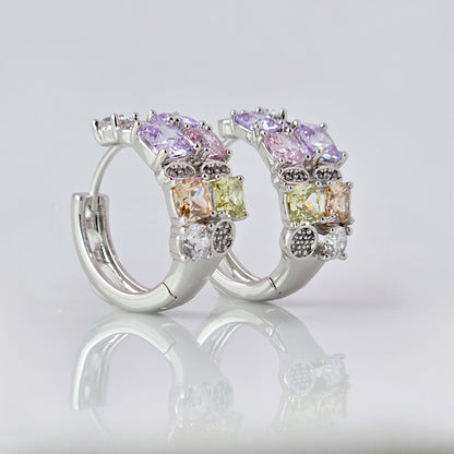 These elegant huggie earrings feature medium-sized silver pink and purple stones. Made from hypoallergenic, tarnish-proof, and sustainable stainless steel, they are low maintenance and lightweight for comfortable all-day wear.