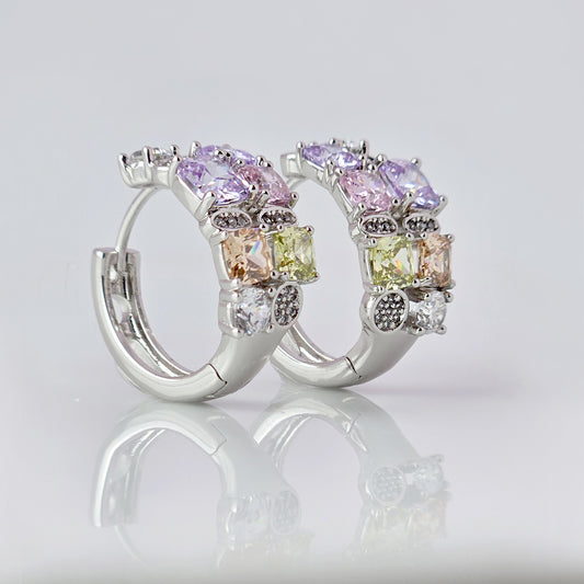 These elegant huggie earrings feature medium-sized silver pink and purple stones. Made from hypoallergenic, tarnish-proof, and sustainable stainless steel, they are low maintenance and lightweight for comfortable all-day wear.